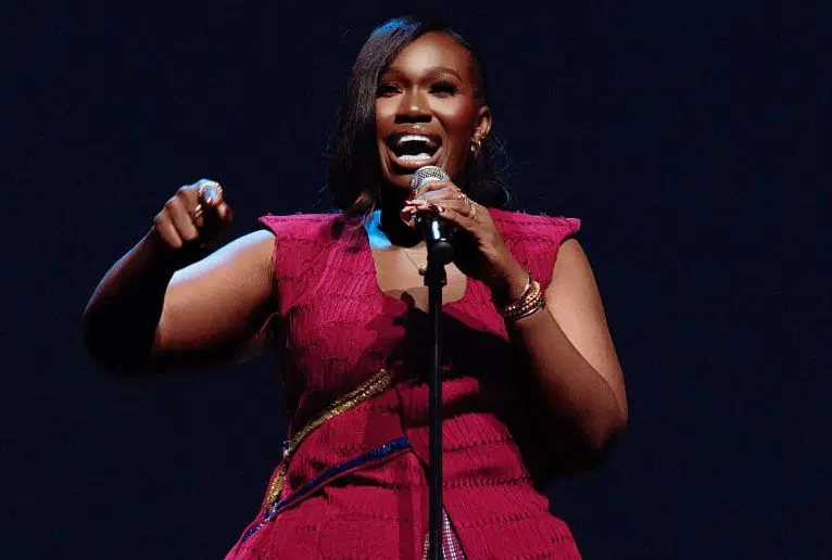 Popular Nigerian female skit maker recording comedy content with smartphone for richest female comedians in Nigeria list